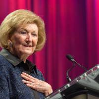 Helen DeVos giving a speech at a podium.